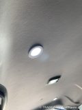 天井に取り付けられ、明るく点灯しているダウンライトの接写。