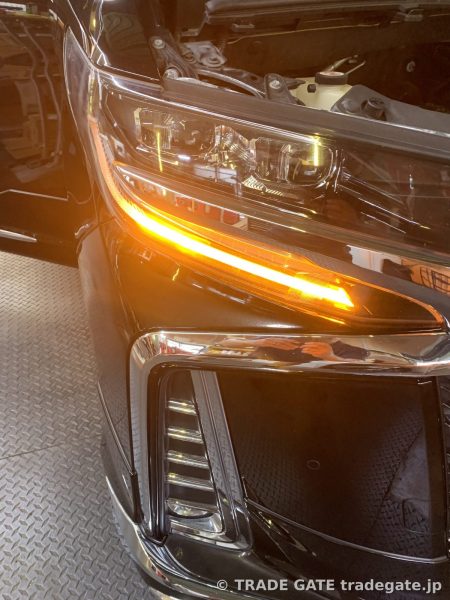 点灯した30系後期アルファードのフロントシーケンシャルウィンカー。アンバー色のLEDが流れる。
