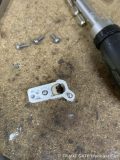 ヘッドライトから取り外されたデイライト部品。溶けた導光チューブと固定ネジが確認できる。